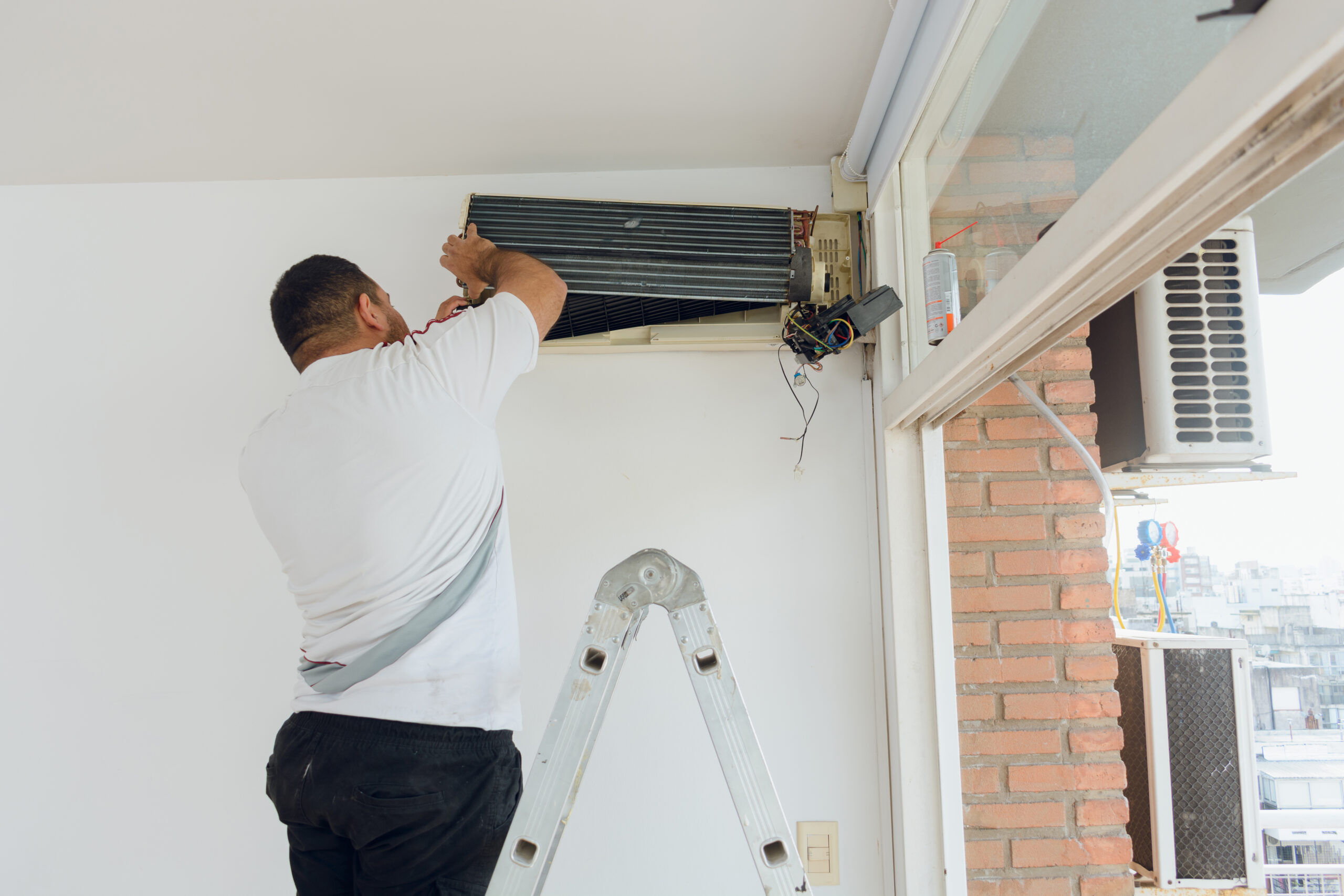 Technician performing AC duct cleaning in Dubai, removing dust and debris for cleaner indoor air